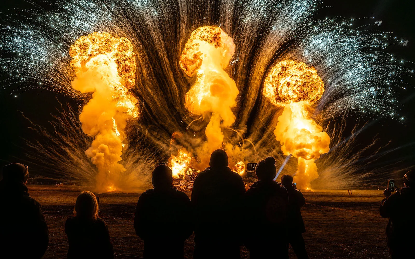 Massive fireballs erupting into the sky at the Wall of Fire