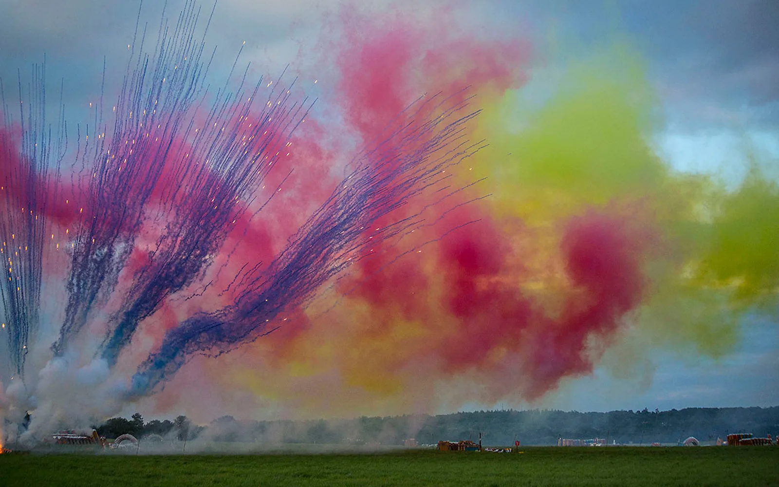 Colourful daylight pyrotechnics with smoke trails at the festival